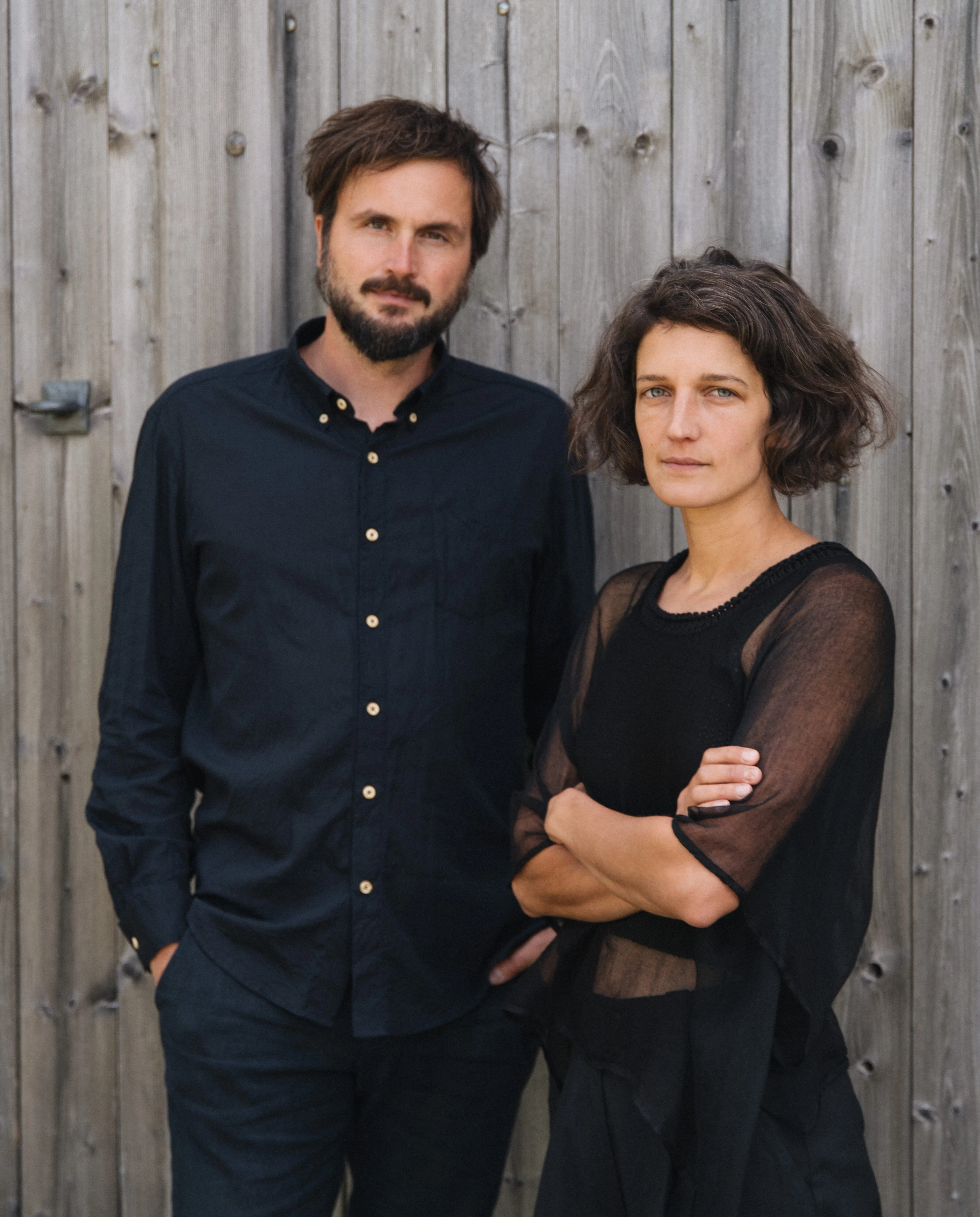 Jan and Zuzana Kurz in front of a wooden wall